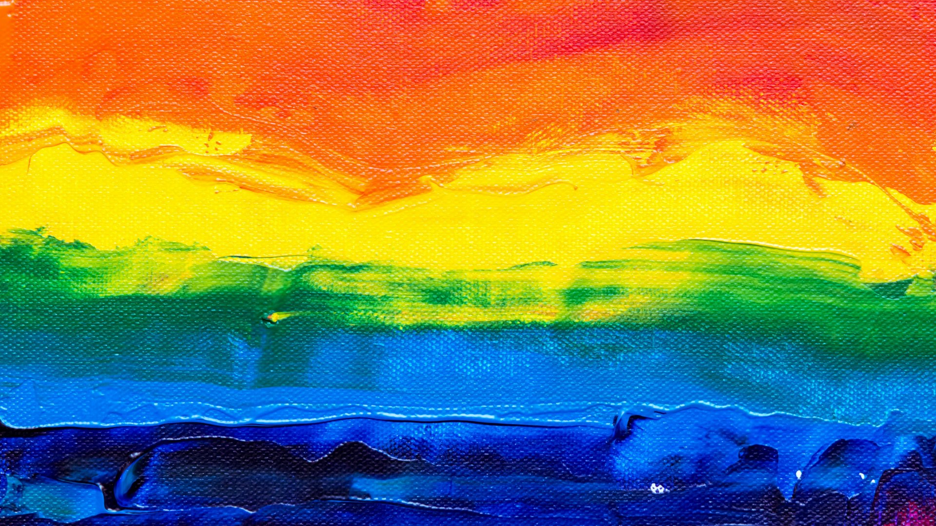 Colorful stripes in rainbow colors painted on canvas.
