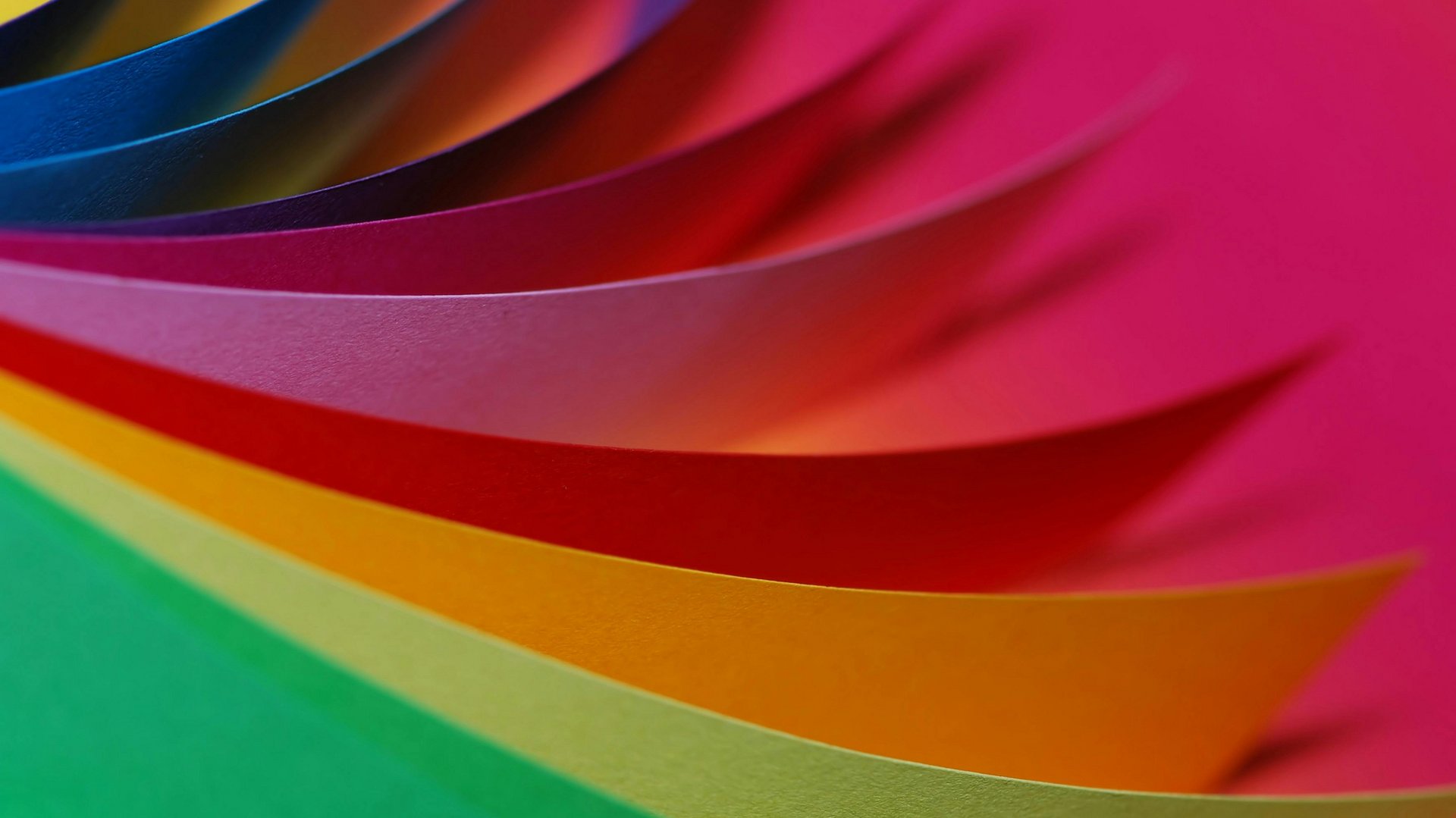 Colorful sheets of paper arranged in curves, intense colors.